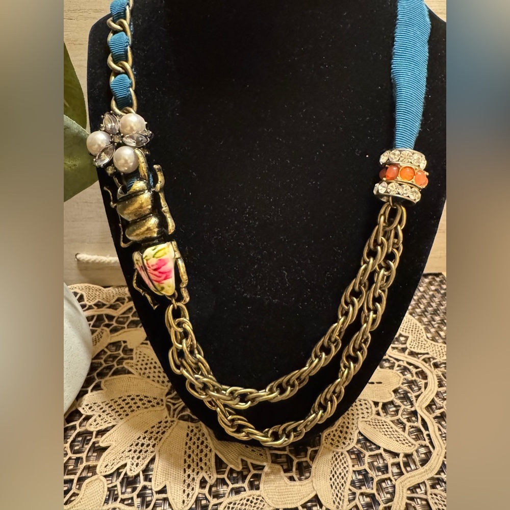 Anthropologie  teal ribbon and porcelain insect necklace w/white crystals & pink